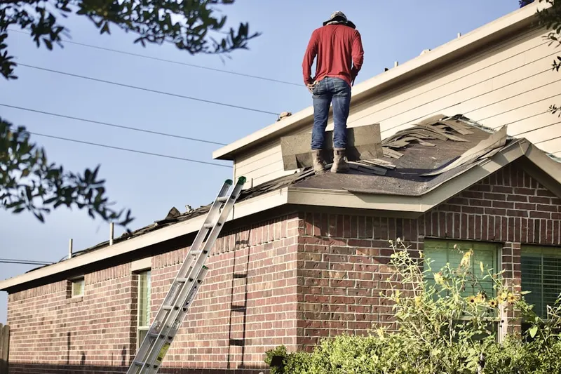 Professional roofer working on a residential roof in McDonogh Park
